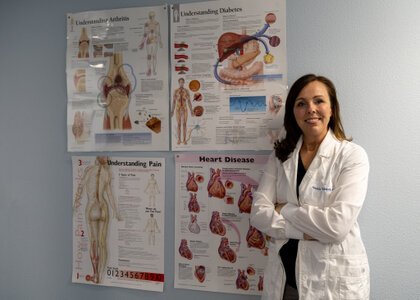 Photo of Nurse Practitioner Amanda Mendoza in front of chart